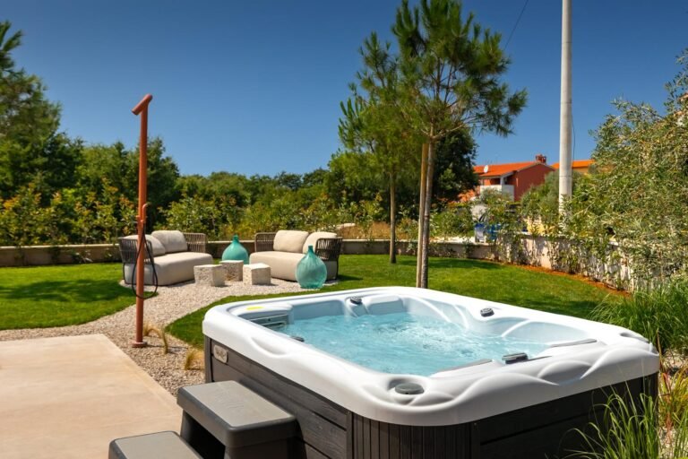 Private outdoor jacuzzi surrounded by garden at luxury villa in Istria, Croatia
