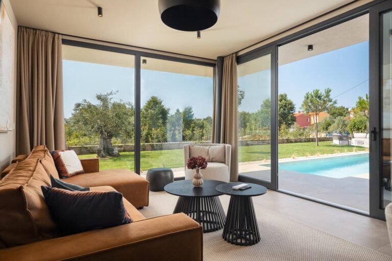 Modern living room with pool and garden view in luxury villa in Istria