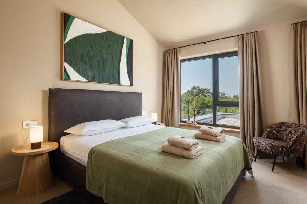 Modern bedroom in luxury villa in Istria near Poreč with garden view