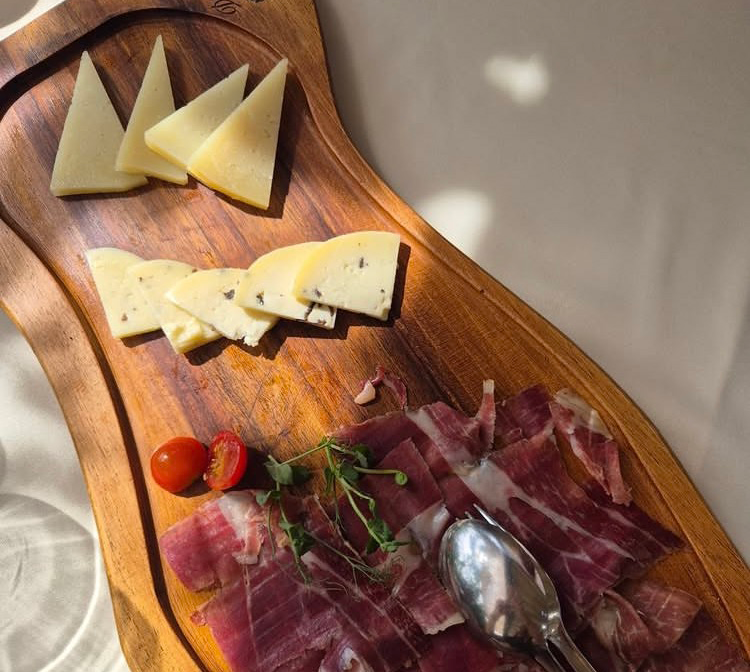 Traditional Istrian prosciutto and local cheese served on a wooden board, a classic Istrian food experience near Poreč