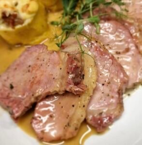 Traditional Istrian pork dish in creamy sauce, authentic local cuisine served in a konoba near Poreč