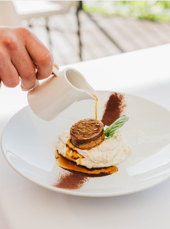 Dessert with sauce being poured at Restaurant Hrast in Poreč